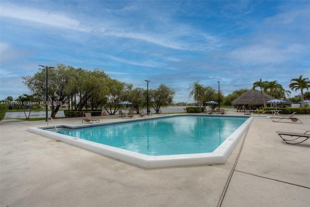 pool with a gazebo and a patio area