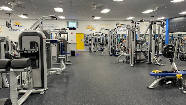 exercise room featuring a drop ceiling and ceiling fan
