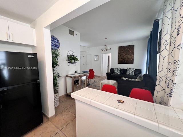 living area featuring visible vents and marble finish floor