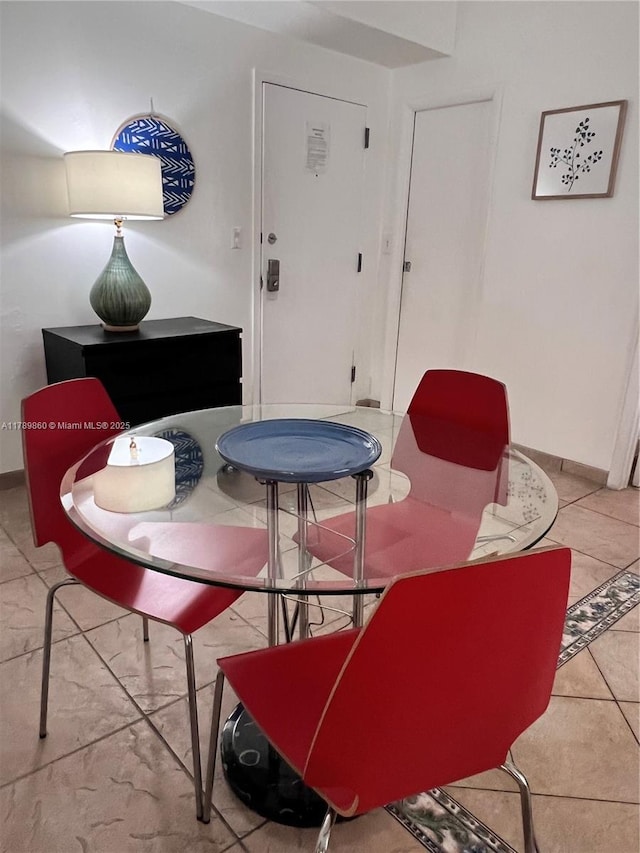 dining room featuring tile patterned floors and baseboards