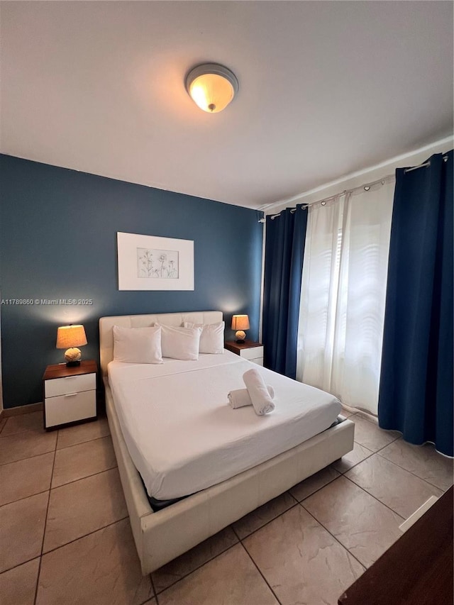 bedroom featuring light tile patterned flooring