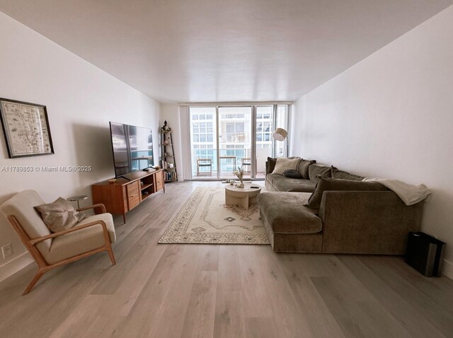 1200 W Ave Unit 1021, Miami Beach, FL 33139 - living area with expansive windows and light wood finished floors