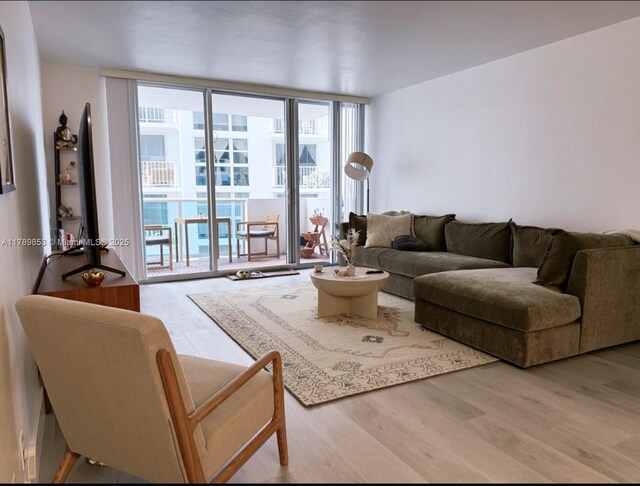 1200 W Ave Unit 1021, Miami Beach, FL 33139 - living room with expansive windows and wood finished floors
