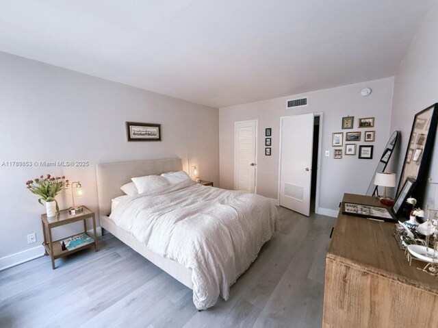 1200 W Ave Unit 1021, Miami Beach, FL 33139 - bedroom with light wood finished floors, baseboards, and visible vents