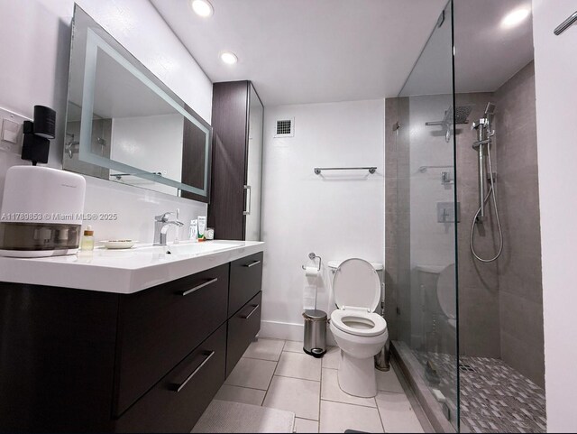 1200 W Ave Unit 1021, Miami Beach, FL 33139 - bathroom featuring toilet, visible vents, tile patterned floors, and a tile shower