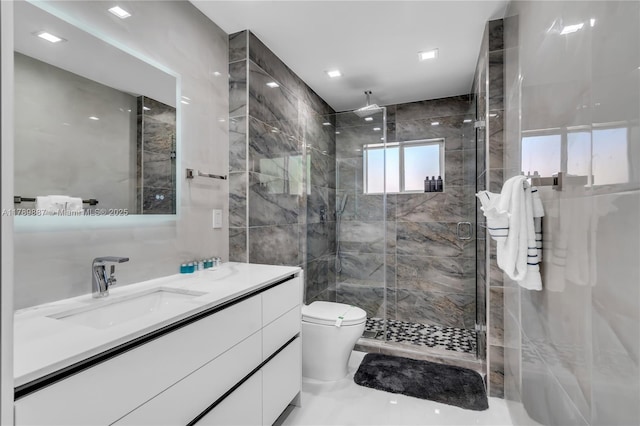 full bath with vanity, toilet, tile walls, and a stall shower