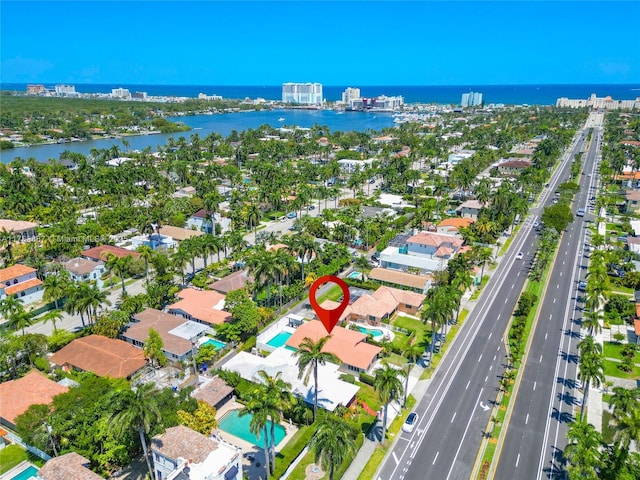 birds eye view of property featuring a city view and a water view