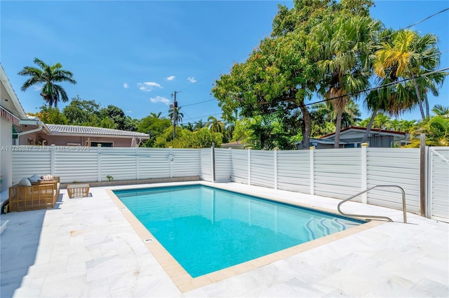 view of pool featuring a fenced backyard, a fenced in pool, and a patio area