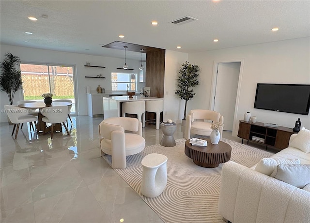 8911 NW 7th Ct, Pembroke Pines, FL 33024 - living room featuring recessed lighting, a textured ceiling, visible vents, and marble finish floor