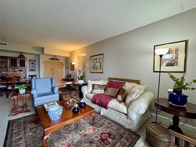 carpeted living room with visible vents and a textured ceiling