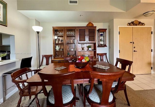 dining room with visible vents and light tile patterned floors