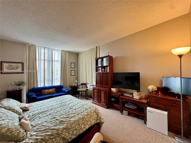 bedroom featuring light colored carpet and a textured ceiling