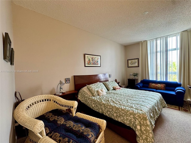 carpeted bedroom featuring a textured ceiling