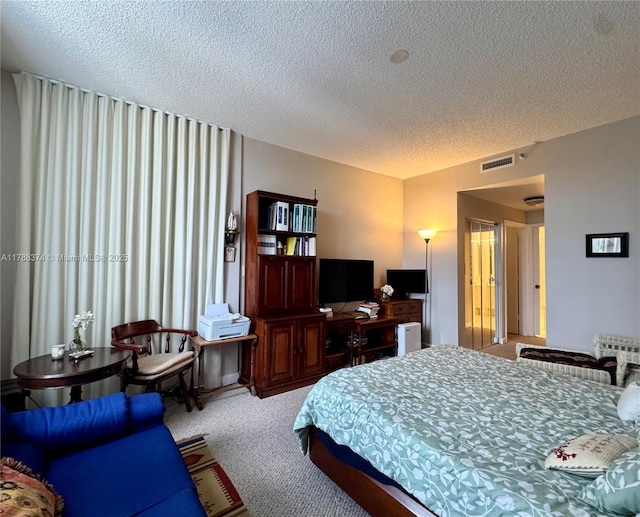 bedroom featuring visible vents, carpet flooring, a textured ceiling, and radiator