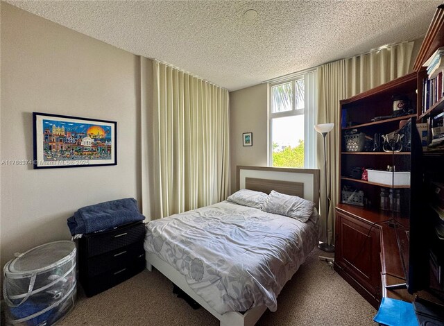 carpeted bedroom with a textured ceiling