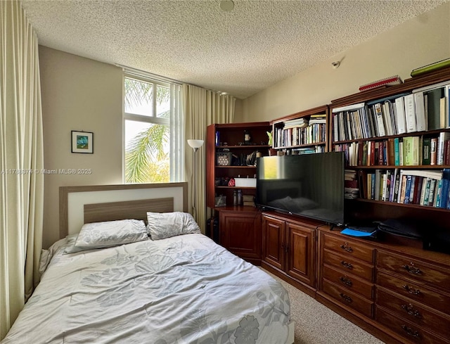 carpeted bedroom featuring a textured ceiling