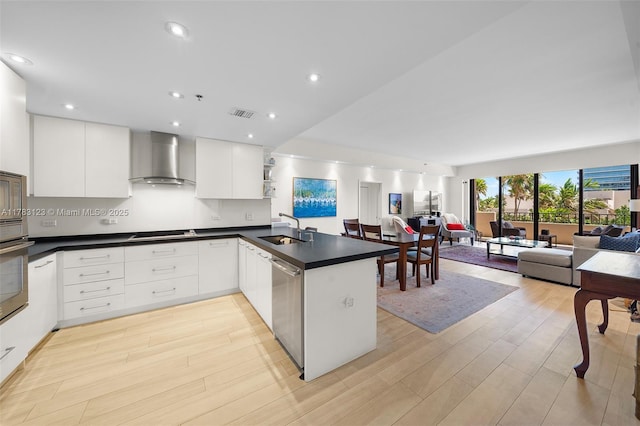 201 Crandon Blvd Unit 333, Key Biscayne, FL 33149 - kitchen featuring wall chimney exhaust hood, stainless steel appliances, open floor plan, a sink, and dark countertops