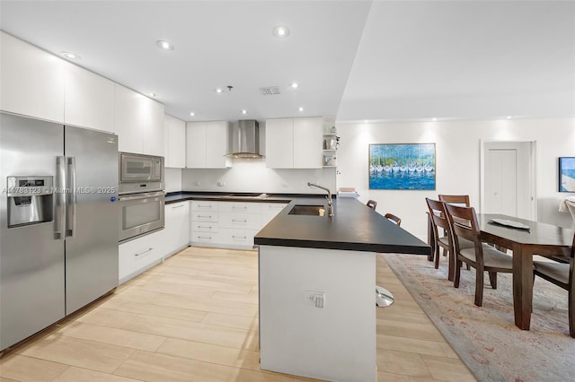 201 Crandon Blvd Unit 333, Key Biscayne, FL 33149 - kitchen featuring stainless steel appliances, wall chimney exhaust hood, a sink, dark countertops, and a peninsula