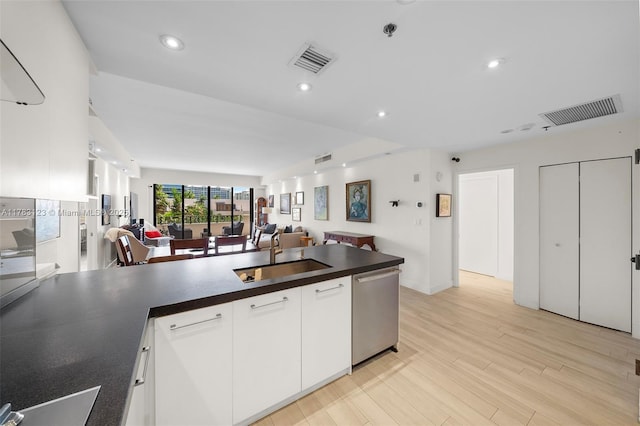 201 Crandon Blvd Unit 333, Key Biscayne, FL 33149 - kitchen featuring a sink, dishwasher, open floor plan, dark countertops, and white cabinetry