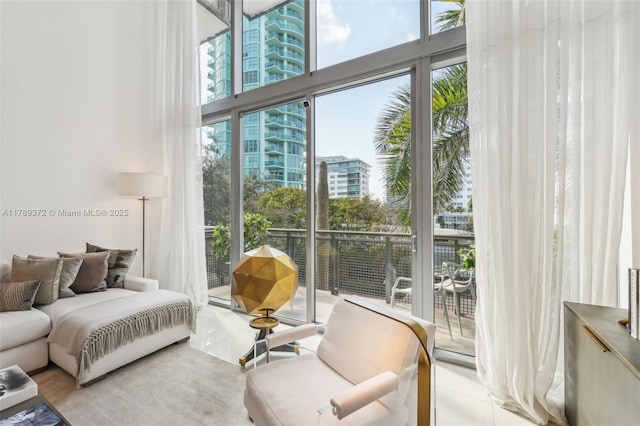 bedroom with a city view, a towering ceiling, and access to outside