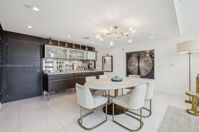dining space featuring wet bar, visible vents, recessed lighting, a chandelier, and light tile patterned floors