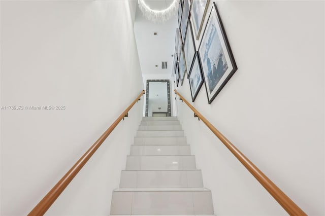 stairs with a towering ceiling and visible vents