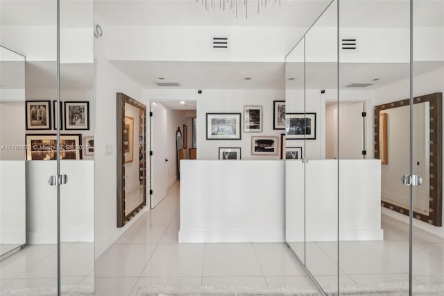 hallway with visible vents and light tile patterned flooring