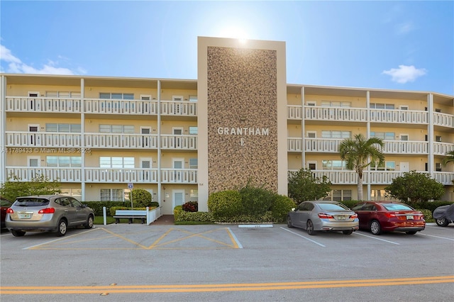 view of building exterior with uncovered parking