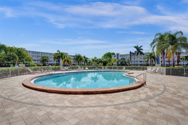 pool with fence and a patio area
