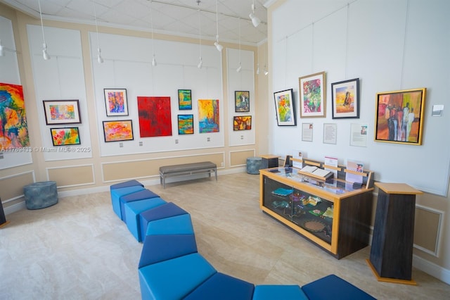 rec room with carpet floors and a decorative wall