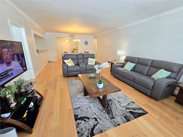 5825 Collins Ave Unit 2D, Miami Beach, FL 33140 - living room featuring visible vents, wood finished floors, ornamental molding, and a notable chandelier
