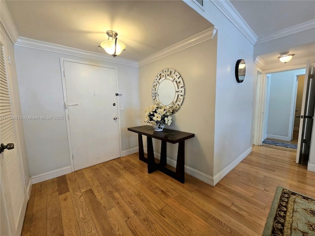 5825 Collins Ave Unit 2D, Miami Beach, FL 33140 - foyer featuring baseboards, crown molding, light wood-style floors, and visible vents