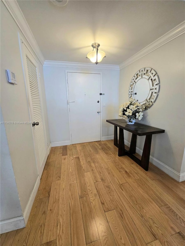 5825 Collins Ave Unit 2D, Miami Beach, FL 33140 - doorway to outside with light wood-style floors, crown molding, and baseboards