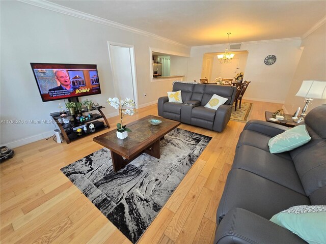 5825 Collins Ave Unit 2D, Miami Beach, FL 33140 - living room with baseboards, wood finished floors, a chandelier, and crown molding