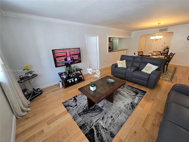 5825 Collins Ave Unit 2D, Miami Beach, FL 33140 - living room featuring visible vents, hardwood / wood-style flooring, a notable chandelier, and crown molding