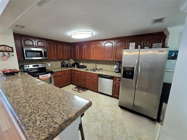 5825 Collins Ave Unit 2D, Miami Beach, FL 33140 - kitchen with a sink, visible vents, a peninsula, and stainless steel appliances