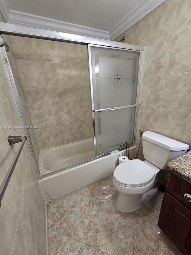 5825 Collins Ave Unit 2D, Miami Beach, FL 33140 - full bathroom with tile walls, vanity, toilet, combined bath / shower with glass door, and ornamental molding