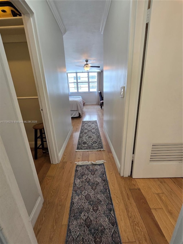 5825 Collins Ave Unit 2D, Miami Beach, FL 33140 - corridor with baseboards, ornamental molding, and light wood-style flooring
