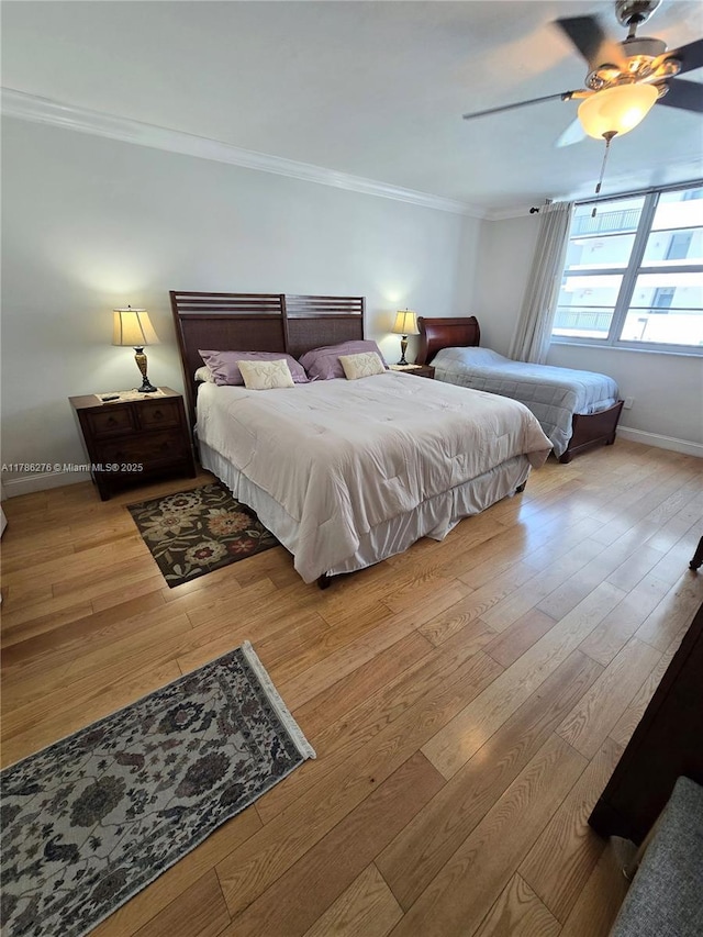 5825 Collins Ave Unit 2D, Miami Beach, FL 33140 - bedroom featuring a ceiling fan, baseboards, crown molding, and wood finished floors