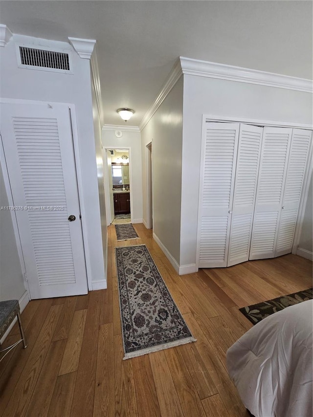 5825 Collins Ave Unit 2D, Miami Beach, FL 33140 - corridor with wood finished floors, visible vents, crown molding, and baseboards