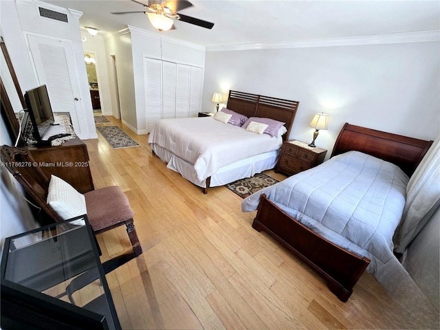 5825 Collins Ave Unit 2D, Miami Beach, FL 33140 - bedroom featuring light wood-style floors, a closet, visible vents, baseboards, and ornamental molding