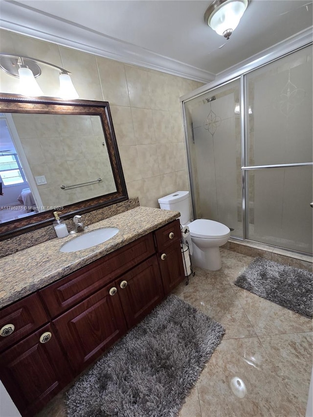5825 Collins Ave Unit 2D, Miami Beach, FL 33140 - bathroom with tile walls, toilet, vanity, a stall shower, and crown molding