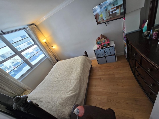5825 Collins Ave Unit 2D, Miami Beach, FL 33140 - bedroom with wood finished floors, baseboards, and ornamental molding