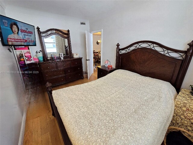 5825 Collins Ave Unit 2D, Miami Beach, FL 33140 - bedroom featuring visible vents and wood finished floors