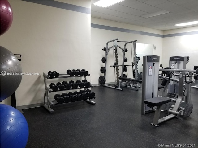 5825 Collins Ave Unit 2D, Miami Beach, FL 33140 - workout area with a paneled ceiling and baseboards