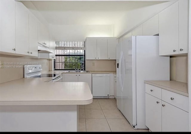 717 NW 105th Pl Unit C2, Miami, FL 33172 - kitchen featuring white appliances, a peninsula, under cabinet range hood, light tile patterned flooring, and light countertops
