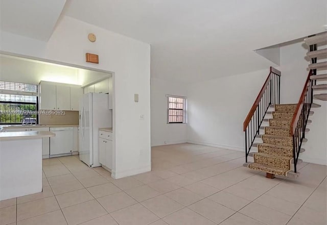 717 NW 105th Pl Unit C2, Miami, FL 33172 - unfurnished living room with healthy amount of natural light, stairway, and light tile patterned flooring