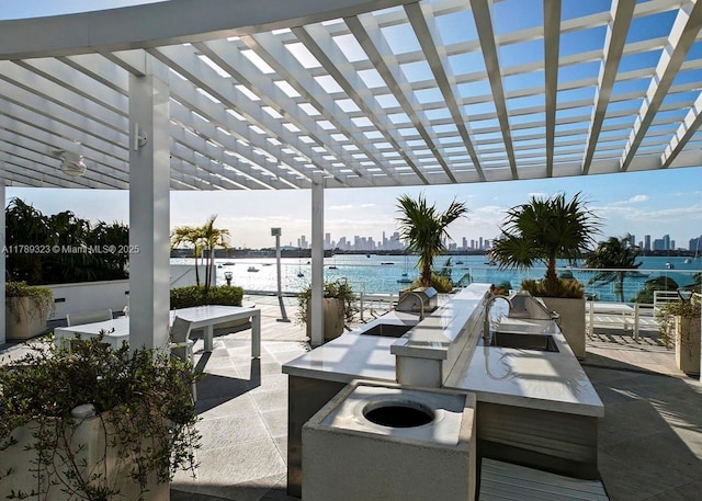 1330 W Ave Unit 1614, Miami Beach, FL 33139 - view of patio featuring a pergola, a water view, and a sink