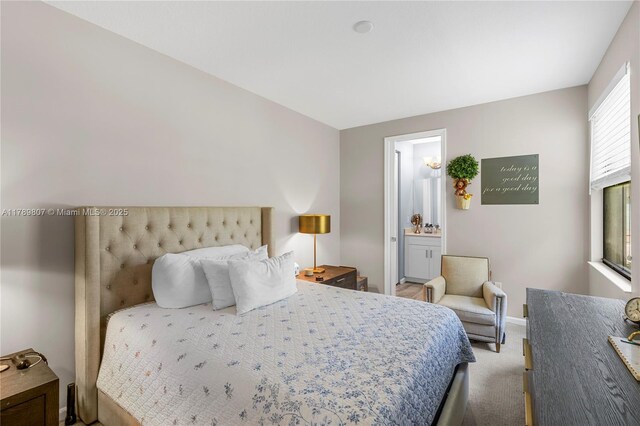 bedroom with baseboards, carpet, and connected bathroom