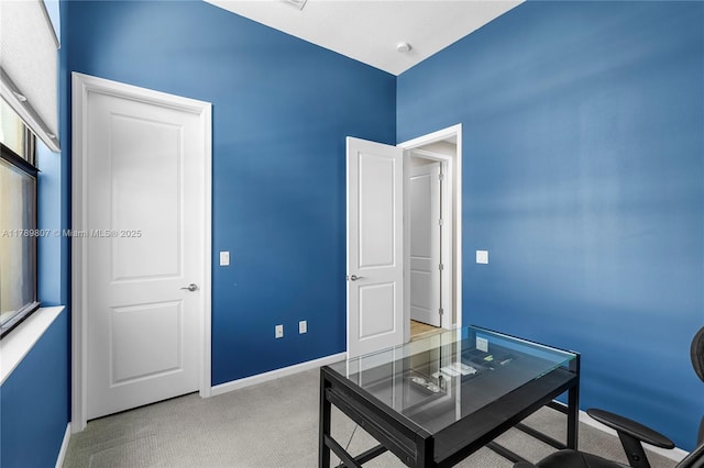 office with light colored carpet and baseboards